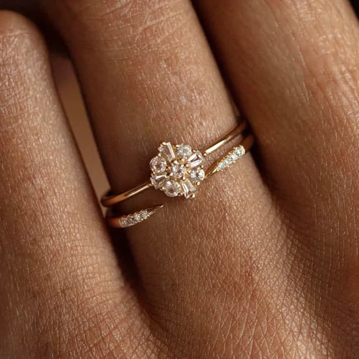 Dainty gold Art Deco cluster diamond ring set, worn on a finger