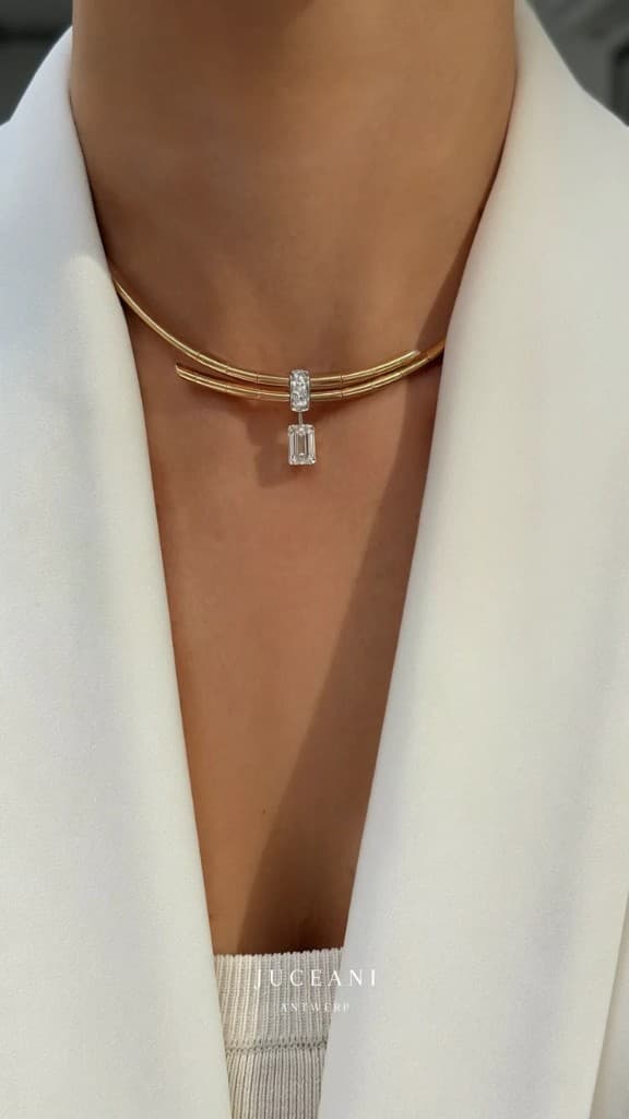 Gold wire choker with a suspended emerald-cut diamond drop, worn on the neck