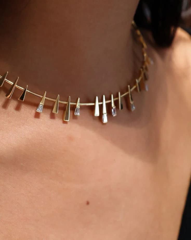 Gold wire fringe choker with baguette diamonds, worn on the neck